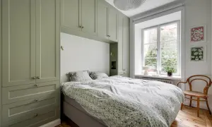 Grön pax garderob som ramar in sängen. Inspiration för smart förvaring i sovrummet.